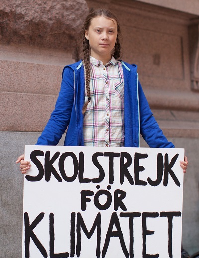 Greta Thunberg outside Sweden's Parliament with her 'strike for climate' sign